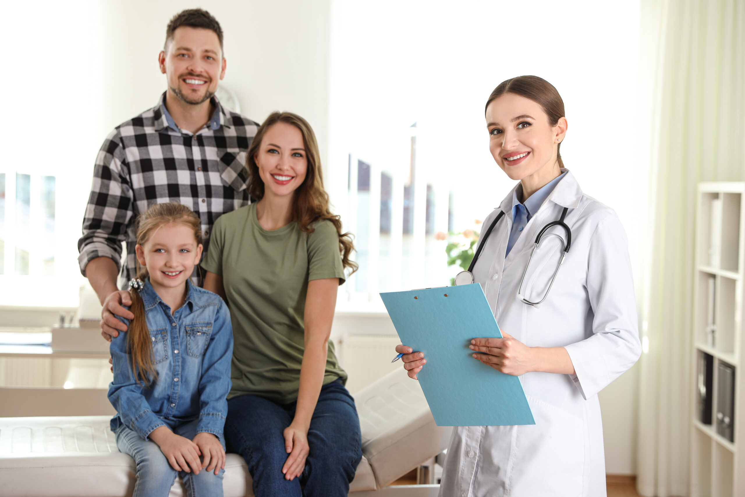 Parents,And,Daughter,Visiting,Pediatrician.,Doctor,Working,With,Patient,In