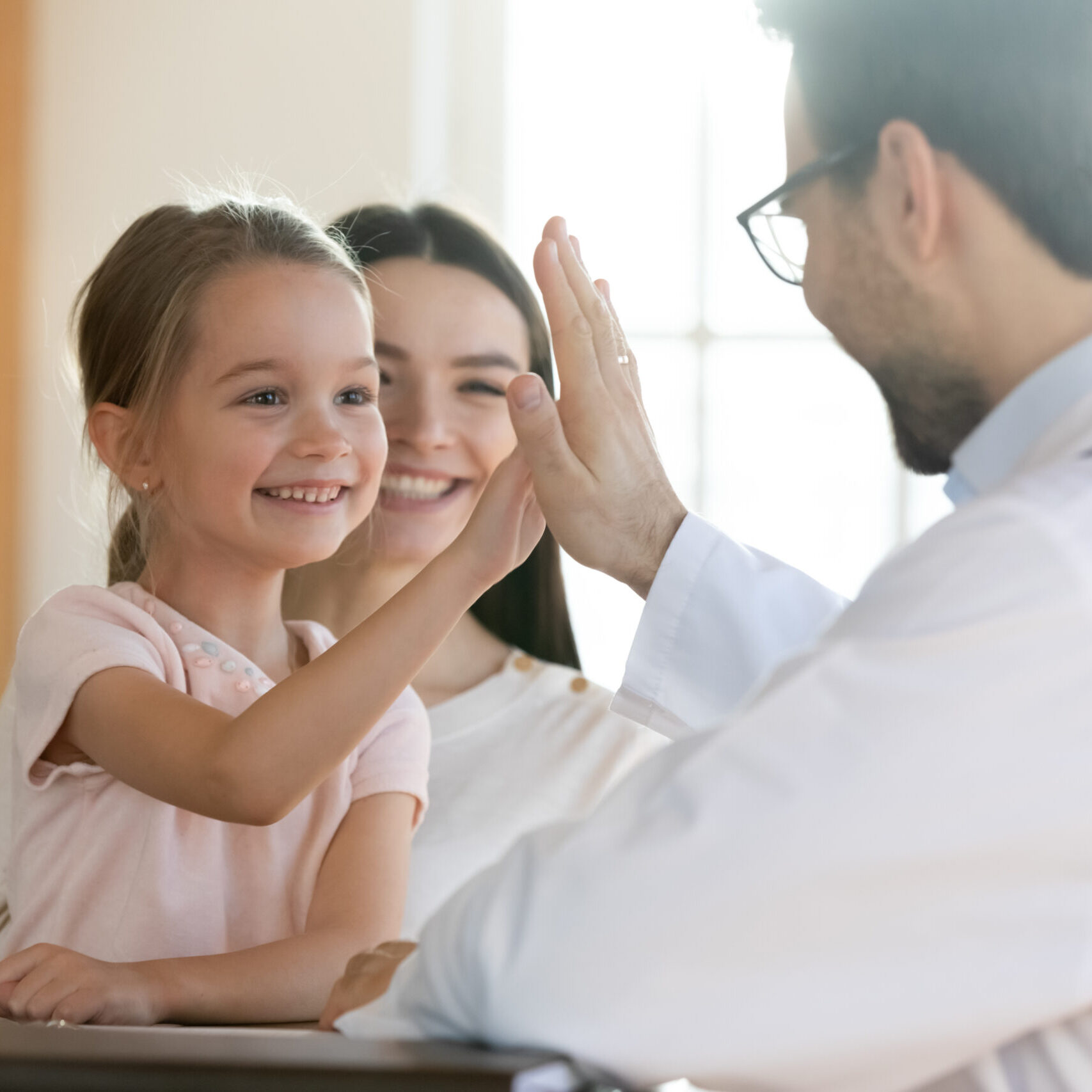 Smiling,Preschool,Girl,Sitting,On,Mum,Laps,,Giving,High,Five